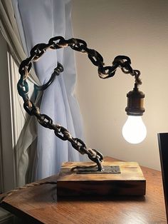 a lamp that is on top of a wooden table next to a lightbulb