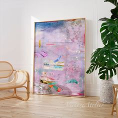 a large painting is hanging on the wall next to a chair and potted plant