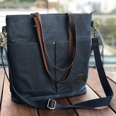 a black bag sitting on top of a wooden table