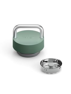 an image of a portable speaker with a ring on the side and a cup next to it