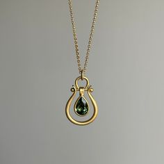 Deep forest greens radiate from this tourmaline pear, suspended within Monika Krol's signature lyre design. 18k yellow gold Tourmaline, 0.89ct, 5mm x 7mm Pendant measures 1/2" x 3/4" Chain is 18" long Lyre Design, Newport Ri, Deep Forest, Jewelry Lookbook, Green Tourmaline, Bracelet Gift, Ring Necklace, Newport, Jewelry Care