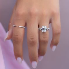 a woman's hand with a diamond ring on it