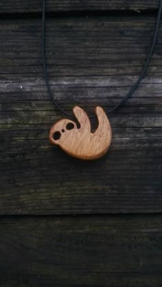 a wooden necklace with a slot design on it