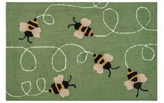 the rug has two bees on it and is green with white lines in the middle