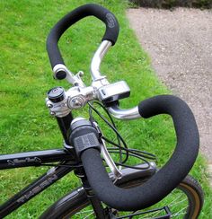 the handlebars on this bike are made from black fabric and have metal fittings