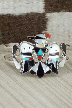 This turquoise, onyx, mother of pearl, coral and sterling silver inlay set was made by Zuni silversmith Bobby Shack. The set is signed B&C Shack, Zuni and Sterling.Necklace: 15"Pendant Length: 2 3/8"Pendant Width: 2 1/4"Earrings:Length: 1 7/8"Width: 3/4"Bracelet:Size: 5" (will fit up to a 6 3/8" wrist)Gap: 1 3/8"Width: 1 5/8"Free shipping on all orders! We ship with USPS and always include tracking. All orders ship within a day of payment.Returns are accepted up to 30 days after you receive your Mother Of Pearl Inlay Jewelry For Gifts, Unique Multicolor Mother Of Pearl Jewelry, Sterling Silver Jewelry With White Inlay, Southwestern Jewelry With Inlay For Gifts, White Sterling Silver Jewelry With Inlay, Southwestern Style Jewelry With Inlay For Gift, Southwestern Style Inlay Jewelry As Gift, Traditional White Jewelry With Inlay, Unique White Jewelry With Inlay