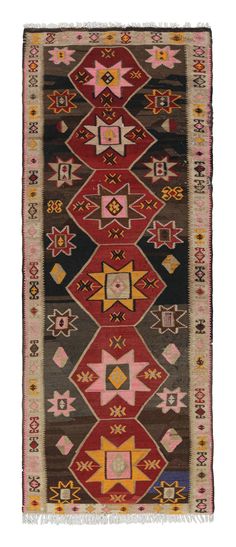 Handwoven in a wool flat-weave originating from Turkey circa 1910-1920, this antique Kilim rug enjoys an early 20th century Kurdish Kilim design, a wide runner in size with both traditional and rare colorways in this take on the time-honored medallion pattern. A Classic beige-brown colorway brings out the unique play of a rich burgundy red with a seldom-seen pink accent in eight-pointed stars dancing through the field and border alike-the most notable and inviting transitional pairing, though regal gold and blue-purple hues can be found attesting to the intriguing variety of hues seen in this antique Kilim design. The comfortable nature of the earth tones plays naturally with the white fringes at the vertical borders, drawing the eye to admire the 4 x 11 size and soothing weave of this ant Kilim Flower, Entryway Runner, Red Turkish Rug, Red Black Turkish Rug, Pink Accents, Patterned Carpet, Turkish Carpet, Purple Hues, Burgundy Red