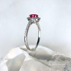 Genuine Ruby Oval Faceted Halo Sterling Silver Ring Add this beautiful pink Ruby halo ring and elevate your jewelry collection. This ring boasts an oval cut natural Ruby gemstone that exudes elegance and sophistication. The accented halo twinkles around the opaque Ruby, while the pave band will take your breath away with its sparkling accent stones. Whether you're treating yourself or looking for the perfect gift for a loved one, this Ruby ring is a beautiful choice for someone looking for a memorable design. Makes a stunning gift for a July birthday recipient as Ruby is the July birthstone. Ruby is considered a stone of love and vitality. Ruby is part of the Corundum crystal family and gets its beautiful pink tones from trace mineral elements of chromium. Sizes Available: 5, 7, 8, 9 DIMEN Oval Ruby Halo Ring With Center Stone, Elegant Oval Ruby Ring With Halo, Elegant Oval Halo Ruby Ring, Pink Ruby Ring With Halo Design, Oval Ruby Halo Ring, White Gold Ruby Ring With Halo, Classic Oval Ruby Ring With Halo Setting, Oval Ruby Ring With Halo In Fine Jewelry Style, Oval Halo Ring With Prong Setting For Proposal