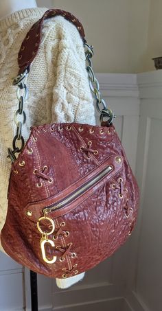 Rare! Authentic Roberto Cavalli brown leather large chain bag in excellent vintage condition. Comes with all tags and a certificate of authenticity. Made of leather using vegetable dyes that has a distinct distressed look. The signature chain is made of tortoiseshell resin, toggle attached to the shoulder strap. Very large size, fits all. Animal print lining with a signature, one zipped pocket, gold metal hardware. Magnetic snap closure. 16" x 12" x 5", strap drop is 7" Vintage Brown Bag With Chain Strap, Vintage Shoulder Bag With Chain Strap For Everyday Use, Brown Leather Shoulder Bag With Chain Detail, Vintage Chain Strap Shoulder Bag For Everyday Use, Vintage Leather Shoulder Bag With Chain Strap, Vintage Roberto Cavalli, Vintage Designer Handbags, Designer Handbag, Refashion Clothes