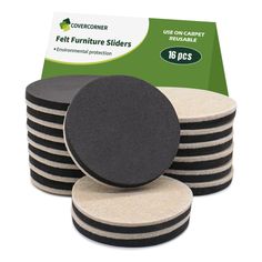 a stack of black and white coasters next to a package of felt furniture slides