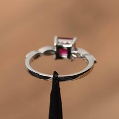 It is a lab ruby ring, princess cut, measures 6mm*6mm, weight about 1.37 cts. The basic metal is sterling silver and plated with rhodium. To change the metal to a solid gold (white/rose) or platinum is also available, please ask for a quotation if you want. You can also go to my shop Home for more elegant rings: https://www.etsy.com/shop/godjewelry?ref=hdr_shop_menu ruby is birthstone of July More ruby rings: https://www.etsy.com/shop/godjewelry?ref=seller-platform-mcnav&section_id=20709238 Asscher Cut Ruby Jewelry With Center Stone, Square Cut Ruby Jewelry Fine Jewelry, Asscher Cut Ruby Ring With Prong Setting For Anniversary, Asscher Cut Ruby Ring For Anniversary, Radiant Cut Ruby Promise Ring With Prong Setting, Anniversary White Gold Ruby Ring With Radiant Cut, White Gold Ruby Ring With Princess Cut, White Gold Princess Cut Ruby Ring, Anniversary Square Cut Ruby Ring Fine Jewelry