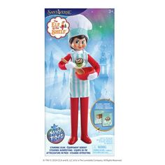 the elf doll is wearing an apron and holding a hot dog in its hand,