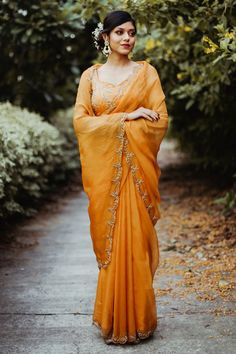 Marigold yellow saree with cutdana and bead embroidered floral motifs. Paired with blouse.
Components:2
Pattern:Embroidery
Type of Work:Cutdana, bead, floral
Neckline:Leaf
Sleeve Length:Sleeveless
Fabric:Silk organza, jacquard silk
Color:Yellow
Other Details:
Scallop bordered saree
Back tie-up blouse
Occasion:Wedding - Aza Fashions Yellow Pre-draped Saree With Resham Embroidery, Yellow Pre-draped Saree With Sheer Dupatta, Festive Yellow Pre-draped Saree For Wedding, Festive Yellow Pre-draped Wedding Saree, Yellow Chanderi Saree For Reception, Yellow Semi-stitched Saree For Reception, Yellow Pre-draped Saree With Dori Work For Reception, Yellow Dola Silk Saree For Reception, Orange Gota Work Saree For Wedding