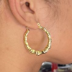 There is nothing more stylish than a pair of 10-karat Yellow Gold Bamboo Hoop Earrings. They're a versatile look that can be paired with any kind of outfit and are suitable for any occasion. The click-snap earring closures support a full hoop shape that is crafted in resilient, eye-catching 10k Yellow Gold. Its gold composition is tougher than most gold types, allowing it to withstand years of daily wear. These hoops measure 1.65 inches from side to side. Bamboo Hoop Earrings are a wonderful gif Trendy Yellow Gold Hoop Earrings, Hinged Hoop Huggie Earrings, Clean Gold Jewelry, Bamboo Hoop Earrings, Nothing More, Shades Of Yellow, Pure Gold, 10k Gold, Pink And Gold