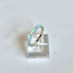 **Current processing time has been reduced to 6-8 weeks. Each ring is made to order in the order received. Thank you so much for your support and patience! 🎁 FREE Wood Ring Box with every ring purchase! 2mm wide Kyocera Solid Opal Ring shimmering with Blue and Turquoise hues. The opal is translucent and when the light hits it, the gold ring comes through in hints of pink. Wrapped around a 14K Gold filled band. Perfect for stacking with a wedding ring or stand alone for a minimalist look. Great Opal Birthstone Ring, Lavender Ring, Blue Fire Opal, Opal Birthstone, Wood Ring, Gold Filled Ring, Green Opal, Rings For Girls, Blue Fire