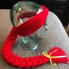 a red rope wrapped around a glass vase