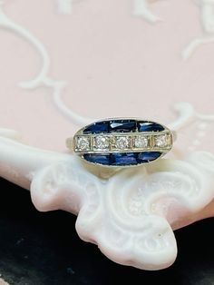 The ring has a lovely structural design with fine openwork filigree, and engravings 5mm wide and sits 4mm high from the finger, with a 1mm shank. Marked PLAT Excellent antique condition Art Deco Oval Sapphire Ring With Prong Setting, Antique Oval Engraved Ring With Diamond Cut, Vintage Sapphire Rings With Intricate Design, Art Deco Oval Sapphire Ring For Anniversary, Art Deco Oval Engraved Rings, Art Deco Engraved Oval Rings, Engraved Oval Sapphire Promise Ring, Collectible Oval Diamond Ring With Intricate Design, Oval Diamond Cut Engraved Ring, Fine Jewelry