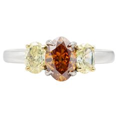 Finely crafted in platinum with a center GIA certified 1.12 carat Fancy Deep Brownish Yellowish Orange diamond. GIA certificate number: 2201779209 The ring features two yellow diamonds weighing approximately a total of 0.60 carats. Orange Diamond, Yellow Diamond Ring, Orange Ring, Gia Certificate, Yellow Diamond Rings, Orange And Yellow, Three Stone Rings, Yellow Diamond, Three Stone