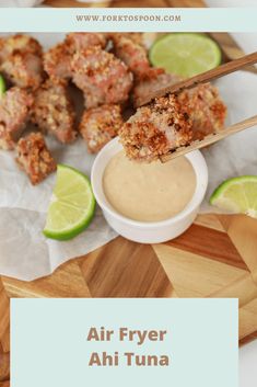 air fryer ahi tuna with dipping sauce on a cutting board next to limes