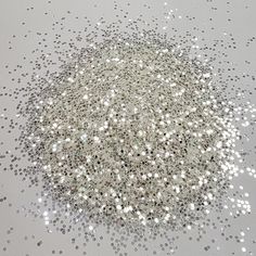 a white table topped with lots of silver glitter