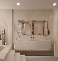 a white bathroom with an oval mirror above the bathtub and cactus in the corner