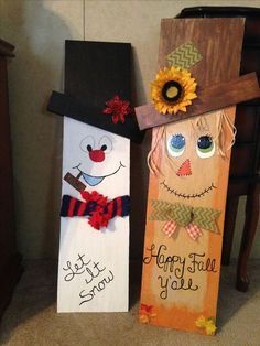 two wooden signs decorated with scarecrows and sunflowers