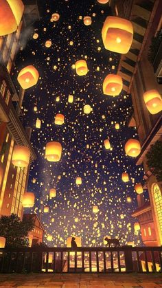 the sky is filled with lanterns floating in the air