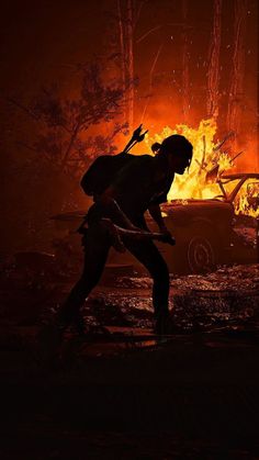 a man holding a stick in front of a fire