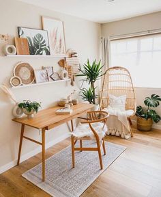 a wooden table sitting in the middle of a living room next to a chair and potted plant