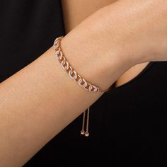 Make a memorable impression with this dazzling diamond bolo bracelet. Crafted in precious 10K rose gold, this shimmering look is created with a curved row of interlocked curb chain - polished links alternating with sparkling diamond-lined links. Radiant with 1/4 ct. t.w. of diamonds and a bright polished shine, this design is centered along a wheat chain that adjusts up to 9.5 inches in length and secures with a bolo clasp and ball ends. Rose Gold Diamond Chain Bracelet Fine Jewelry, Rose Gold Diamond Chain Bracelet, Adjustable Rose Gold Chain Bracelet For Anniversary, Rose Gold Diamond Chain Bracelet For Anniversary, Adjustable Rose Gold Diamond Bracelet, Anniversary Rose Gold Diamond Chain Bracelet, Adjustable Rose Gold Tennis Bracelet For Anniversary, Rose Gold Diamond Bracelet With Adjustable Chain, Adjustable Chain Rose Gold Diamond Bracelet