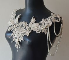 Add a touch of vintage charm and elegance to your bridal look with this stunning Beige Lace Shoulder Necklace. Designed to enhance your wedding day ensemble, this unique piece is perfect for brides seeking a romantic and sophisticated accessory. Elegant Design: The shoulder necklace drapes gracefully over your shoulders, adding a unique and romantic touch to your bridal outfit. Versatile Use: Ideal for weddings, receptions, and other special occasions. Complements various bridal gowns and styles Shoulder Jewelry, Shoulder Necklace, Weddings Receptions, Bridal Outfit, Classic Brides, Necklace Elegant, Pearl And Lace, Ivory Pearl, Unique Necklace