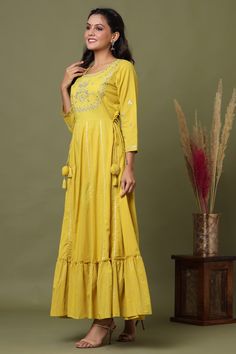 Single Piece Fabric-Cotton Color-Yellow Work- Embroidery, lace & mirror detailing with side tassels Style-Anarkali Style Length-Ankle Length Sleeves-3/4th Sleeves Neck-Round Neck Occasion-Casual wear Washing care-Hand wash Festive Straight Kurta Sharara With Tassels, Festive Sharara With Tassels And Straight Kurta, Traditional Anarkali Set With Tassels For Designer Wear, Festive Bollywood Kurta With Tassels, Designer Anarkali Set With Tassels For Diwali, Festive Kurta With Tassels, Festival Kurta With Tassels, Designer Salwar Kameez With Tassels For Eid, Diwali Anarkali Set With Straight Kurta And Tassels