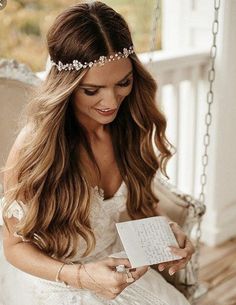 a woman wearing a tiara sitting on a swing