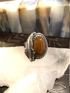 FREE SHIPPING This is such a beautiful Ring! This Ring is made with Sterling Silver and has a beautiful Tigers Eye Stone in it, adorned with a big silver leaf. This can be a Man or Womens Ring. It is size 8 3/4. It is an inch high and almost an inch wide. It has beautiful sterling silver work. The inside is signed by the craftsman, Rogelio Arte and is stamped 925. (I'm not 100% positive that is what the signature says, hard to tell...see all pics). You will LOVE this Ring. It is gorgeous and a g Western Sterling Silver Gemstone Ring, Western Style Sterling Silver Gemstone Ring, Western Style Untreated Sterling Silver Rings, Bohemian Untreated Sterling Silver Ring, Jewelry Men Ring, Tigers Eye Stone, Woman Ring, Womens Ring, American Indian Jewelry