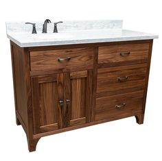 a bathroom vanity with marble top and two faucets