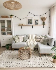 a living room filled with lots of furniture and decor on top of a white rug