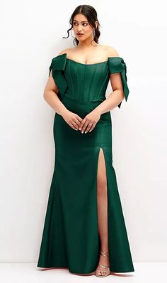 a woman in a green dress posing for the camera