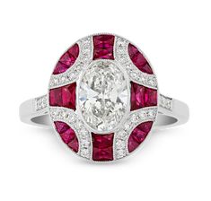 This exquisite Art Deco-style cocktail ring is centered by an oval-cut diamond weighing 1.00 carat, certified by the Gemological Institute of America as having exceptional E color and VS2 clarity. The center stone is complemented by the rich, vibrant hues of accent rubies totaling 0.65 carat and additional diamonds with a combined weight of 0.17 carat, all distributed in a unique geometric pattern. Illustrating all of the Art Deco era’s most marvelous characteristics, this harmonious blend of co Luxury Oval Diamond Ring With Lab-created Ruby, Luxury Ruby Ring With Oval Center Stone, Luxury Oval Ruby Ring With Center Stone, Oval Ruby Ring With Diamond Center Stone, Classic White Oval Ruby Ring, Oval Ruby Ring With Platinum Center Stone, Oval Ruby Ring With Platinum Band, Oval Ruby Ring With Platinum, Oval Ruby Ring With Platinum Setting