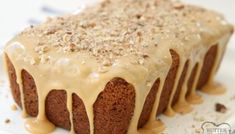 a close up of a cake on a plate with icing and nuts around it