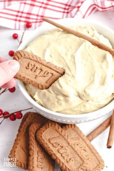 a bowl filled with cream cheese surrounded by crackers