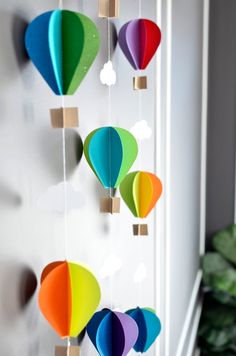 colorful paper hot air balloons hanging on a wall