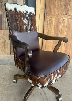 a brown and white cowhide office chair