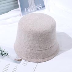 The Emes Shop hat is detailed with a sleek minimalist design. Features a solid color. wool material. and cloche hat design.MATERIAL:100% Brushed Wool BlendCIRCUMFERENCE MEASUREMENTS: 56-58cm 22-23in Winter Wool Brimmed Cloche Hat, Wool Brimmed Cloche Hat For Winter, Winter Wool Cloche Hat, Winter Wool Cloche Felt Hat, Chic Winter Wool Fedora, Chic Wool Fedora For Winter, Fall Wool Cloche Hat, Beige Felt Hat With Short Brim For Winter, Beige Short Brim Felt Hat For Winter