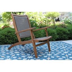 a wooden chair sitting on top of a blue rug