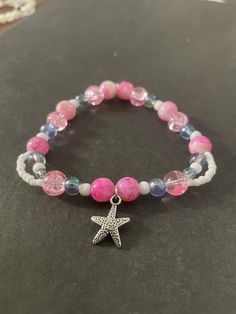 A fun and unique bracelet designed for a medium wrist. I make a different assortment of styles for each size, so your jewelry will be exclusive to you! Bohemian Adjustable Bracelet With Star Charm, Silver Starfish Beaded Bracelet Gift, Silver Starfish Shaped Beaded Bracelet Gift, Silver Beaded Bracelet With Starfish Charm As Gift, Trendy Pink Bracelet With Faceted Beads, Starfish Charm Bracelet As A Gift, Starfish Charm Bracelet As Gift, Starfish Charm Bracelet Gift, Star-shaped Bracelet With Starfish Charm Gift