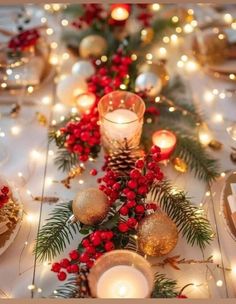 a table with candles and christmas decorations on it