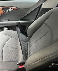 the interior of a car with grey leather