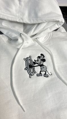 One (1) Steamboat Willie Hoodie or Sweatshirt Sweatshirt: Hanes 50/50 cotton/poly Hoodie: Jerzees 50/50 cotton/poly NuBlend® pill-resistant fleece Follow our care instructions: Wash in cold water with similar colors, avoid bleach, tumble dry on low, and iron on low heat if necessary. Do not dry clean. White Long Sleeve Hoodie With Embroidered Graphics, White Hoodie With Custom Embroidery For Winter, White Hoodie With Custom Embroidery, White Long Sleeve Hoodie With Custom Embroidery, White Custom Embroidered Hooded Sweatshirt, White Hooded Sweatshirt With Custom Embroidery, White Fleece Crew Hoodie, Casual Hoodie With Machine Embroidery For Streetwear, White Hooded Hoodie With Embroidered Graphics