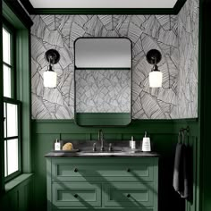 a bathroom with green walls and a mirror on the wall above the sink is an art deco style