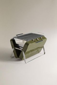 an outdoor grill sitting on top of a table